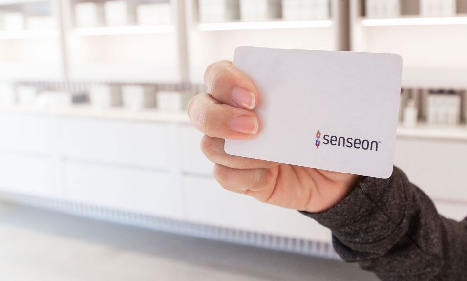 Woman holding Senseon RFID keycard